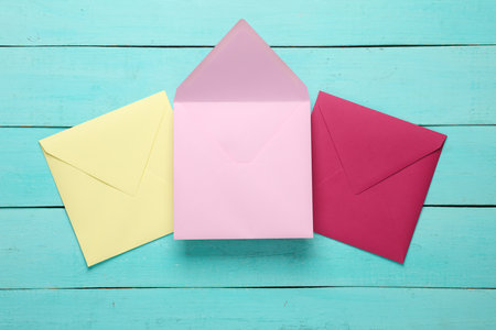 Set of colored envelopes on blue wooden boards. Creative layout