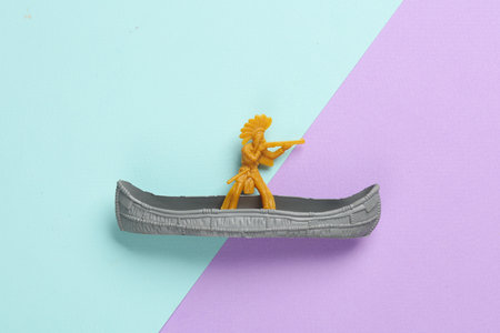 American Indian soldier in canoe on pastel background. Wild west, western. Minimalismの写真素材