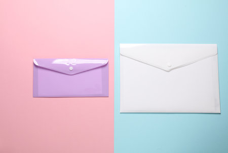 Plastic envelopes on a pink blue backgroundの写真素材