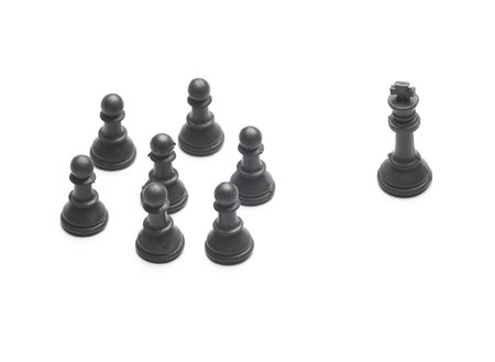 Black chess pieces on a white background. Leadership concept