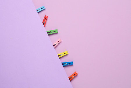 Lot of colorful clothespins on a purple background