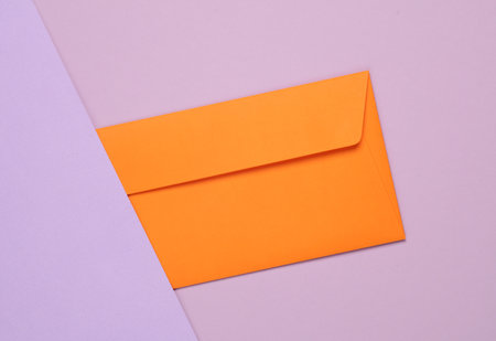 Orange envelope on a pastel background. Creative layoutの写真素材
