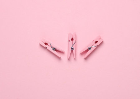 Pink clothespins on pink backgroundの写真素材