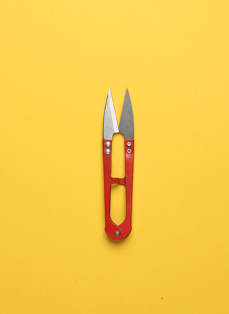 Fishing or tailor scissors on yellow backgroundの写真素材