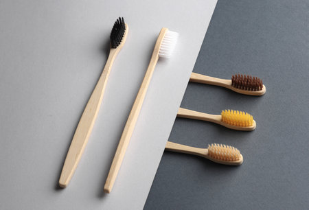 Eco bamboo toothbrushes on gray background. Creative layout, Minimalism