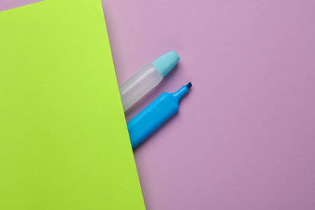 Accessories for creativity. Glue with a marker on a green-purple backgroundの写真素材