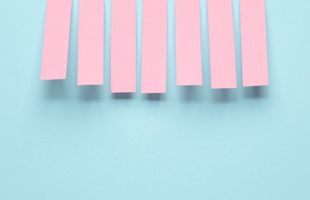 Pink blank note memo stripe stickers on blue pastel backgroundの写真素材