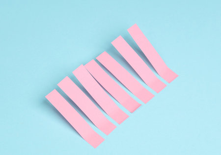 Pink blank note memo stripe stickers on blue pastel backgroundの写真素材