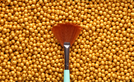 Makeup brush on Bronze make up powder balls. Beauty concept