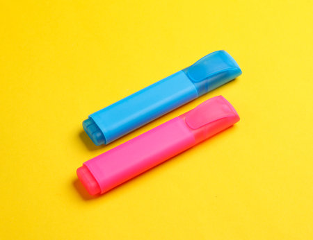 Blue and pink marker on yellow backgroundの写真素材