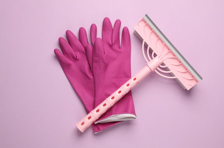 Window cleaning mop with gloves on pink background. Top viewの写真素材