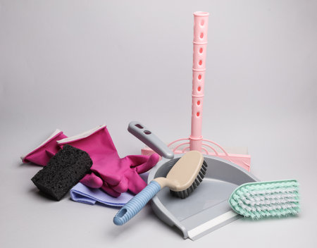 Many home cleaning accessories on a gray backgroundの写真素材