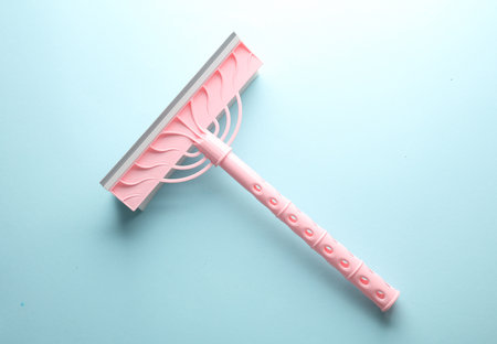 Window cleaning mop on blue background. Top view