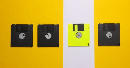 Outdated technologies. Retro floppy disk on a yellow-white background. Back to the 80s. Minimalistic layout. Top viewの写真素材