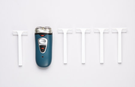 Electric shavers and razors on white background. Flat layの写真素材