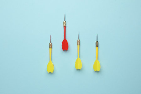 Yellow and red darts needles on blue background. Leadership, Business conceptの写真素材