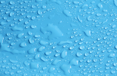 Blue background in water drops close up