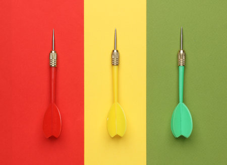 Darts needles on colored background. Top view