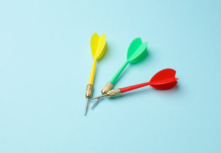 Yellow, green and red darts on blue background.