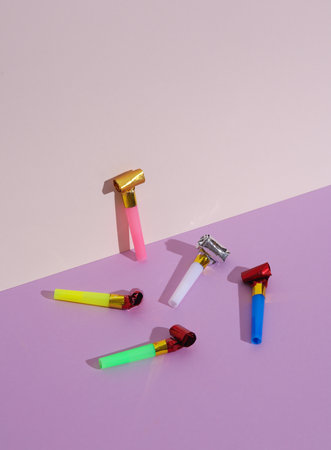 Birthday horns on a blue-pink pastel background. Minimal party concept, happy birthday, creative...