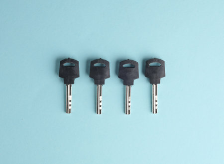 Four keys on a blue background. Top viewの写真素材
