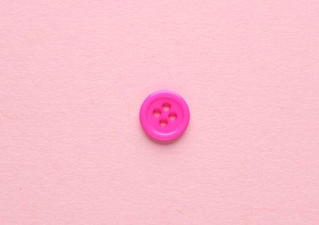 Plastic pink buttons on pink background. Minimalism