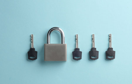 Closed metal lock with keys on a blue background
