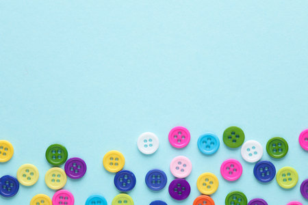 Many colored plastic buttons on a blue background. Copy spaceの写真素材