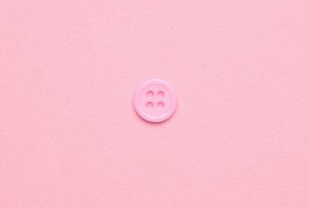 Plastic pink buttons on pink background. Minimalism