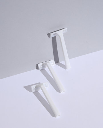 White razors on a white gray background. Beauty concept. Creative layout, minimalismの写真素材