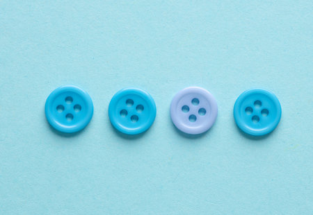 Plastic blue buttons on a blue backgroundの写真素材