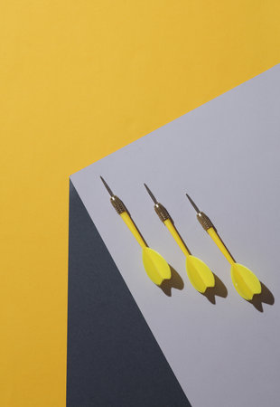 Darts on the corner of gray cube. Optical geometric illusion. Creative layout. Minimalism. Business conceptの写真素材
