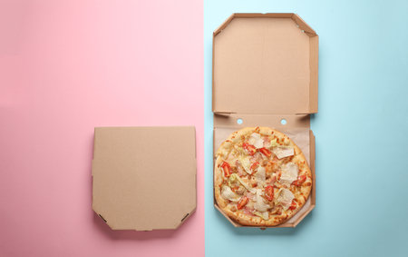 Open and closed pizza boxes on a pink blue background. Template for design. Top viewの写真素材