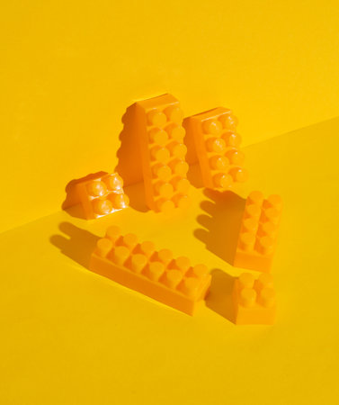 Toy bricks constructor on a yellow background. Creative layoutの写真素材