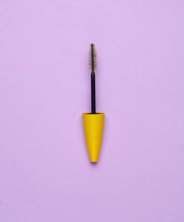 Mascara brush on purple background. Beauty conceptの写真素材