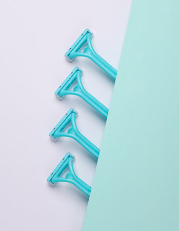 Blue Plastic razors on a paper background. Beauty conceptの写真素材