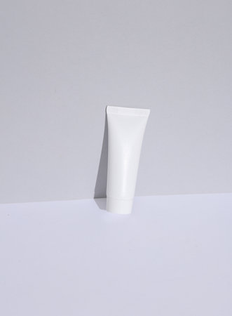 White tube of cream on a white background with a shadow. Creative beauty layout. Mockup, template for designの写真素材