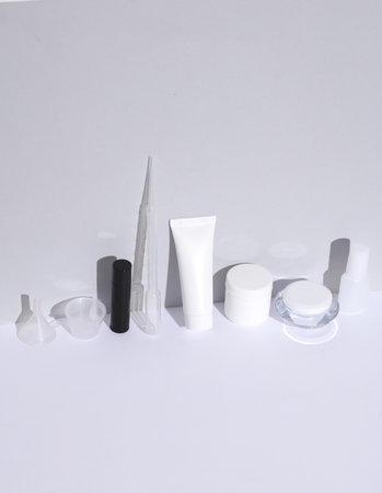 Accessories for handmade cream on a white background with a shadow. Beauty concept