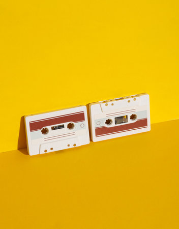 Retro 80s audio cassettes on yellow background with shadow. Creative layout, minimalism, music loverの写真素材
