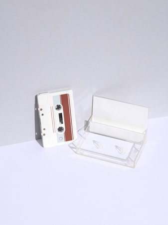 Retro 80s white audio cassette with box on white background with shadow. Creative layout,...
