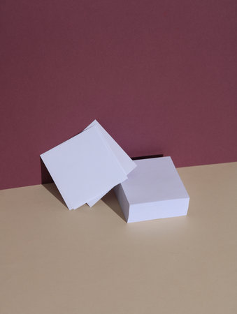 Memo papers on burgundy beige background with shadow. Creative layout. Minimal business concept....