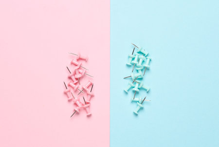 Stationery pins on a pink blue pastel background.