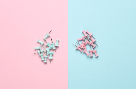 Stationery pins on a pink blue pastel background.の写真素材