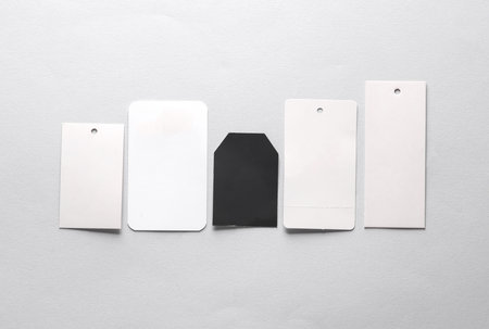 Different price tags on a gray background. Mockup, template for design
