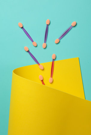 Set of applicators for makeup on a yellow blue background