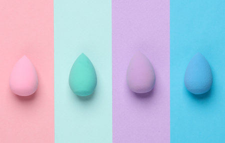 Make-up sponges, cosmetic beauty blenders on colored background. Top view. Flat layの写真素材