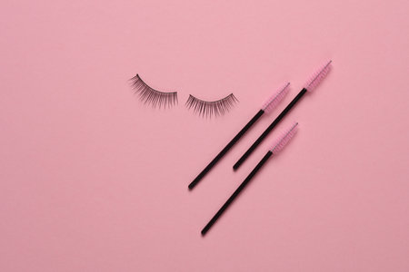 Set of brushes for combining eyelashes, false eyelashes on pink background. Beauty conceptの写真素材