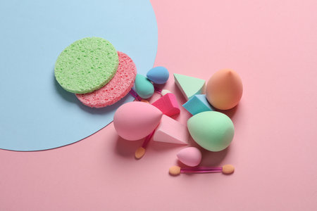 Make-up sponge, cosmetic blenders and applicators for makeup on pink blue background. Beauty products.の写真素材