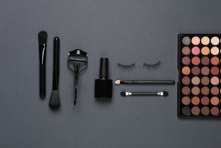 Set of beauty products, make-up accessories on a dark background. Flat layの写真素材