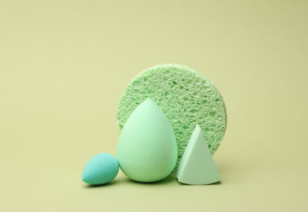 Remover sponge and make-up blenders on green background. Beauty conceptの写真素材